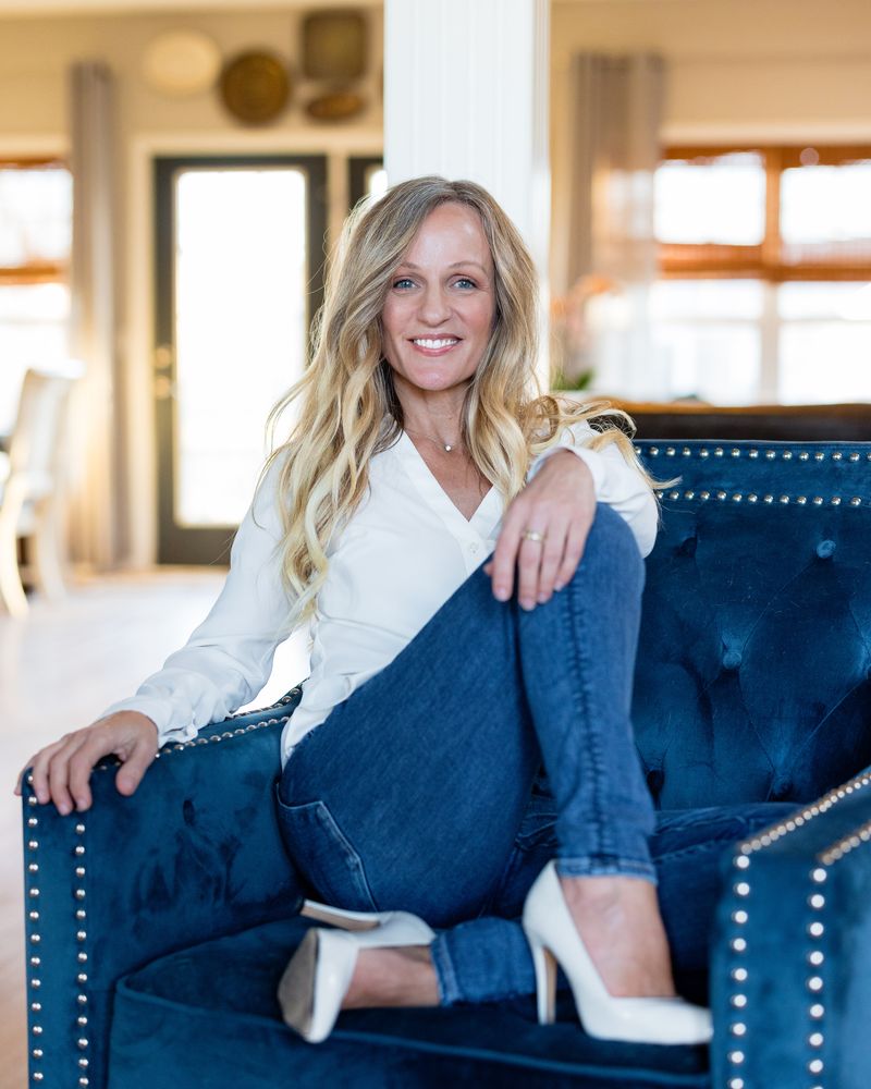Molly A. Jones smiling, seated in a navy chair
